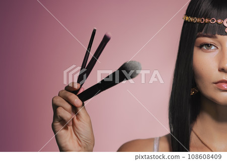 Cleopatra Half Face Beauty Fashion Portrait of Female Model with Makeup Brushes Cleopatra Half Face Beauty Fashion Portrait of Female Model with Makeup Brushes 108608409