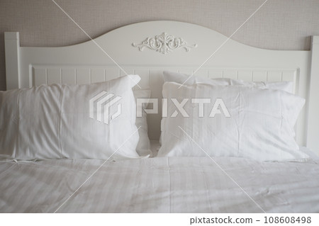 white pillow lined up on bed  108608498