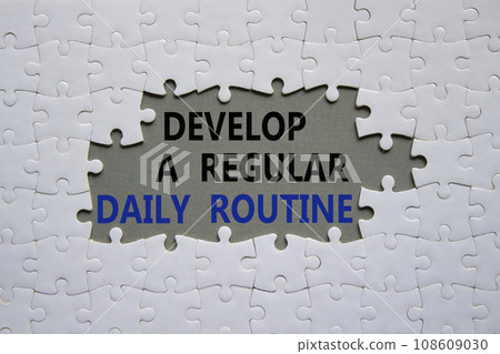 Daily routine symbol. Concept words Develop a regular daily routine on white puzzle. Beautiful grey background. Business and Develop a regular daily routine concept. Copy space. Daily routine symbol. Concept words Develop a regular daily routine on white puzzle. Beautiful grey background. Business and Develop a regular daily routine concept. Copy space. 108609030