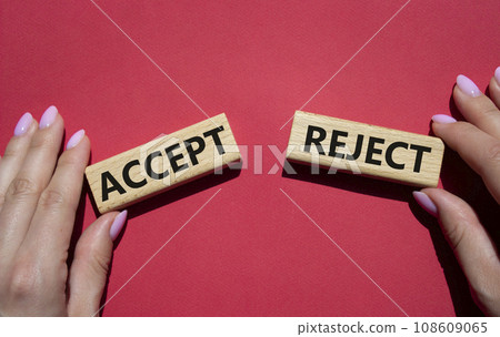 Accept or Reject symbol. Concept word Accept or Reject on wooden blocks. Businessman hand. Beautiful red background. Business and Accept or Reject concept. Copy space 108609065