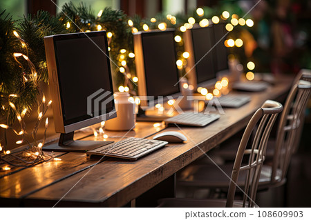 two computers on a desk with christmas lights in the background and an image of a laptop, keyboard and mouse two computers on a desk with christmas lights in the background and an image of a laptop, keyboard and mouse 108609903