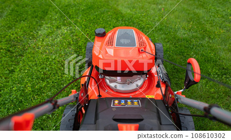 durable smooth lawn mower on green grass durable smooth lawn mower on green grass 108610302