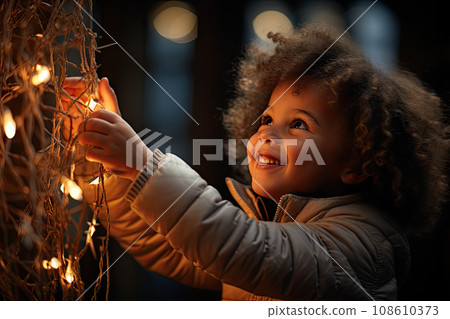 a little girl that is looking up at the lights on her christmas tree she's wearing a white jacket a little girl that is looking up at the lights on her christmas tree she's wearing a white jacket 108610373