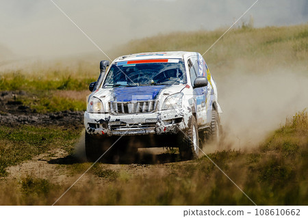 racing car high speed moving on dusty road during cross country rally 108610662