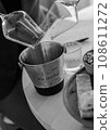 pouring wineglasses in spittoon at wine tasting black and white 108611272