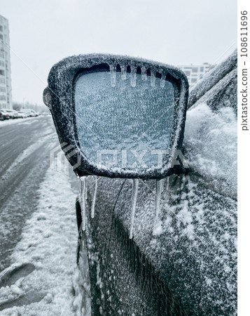 car covered with ice after snowstorm 108611696