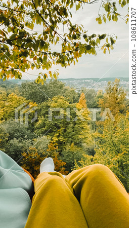 pov woman sitting on hammock looking at autumn forest pov woman sitting on hammock looking at autumn forest 108611707