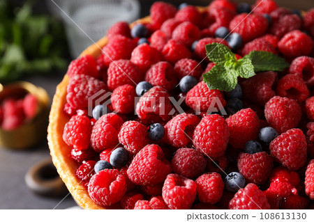 Berry pie with raspberries, blueberries and mint on wooden background, close up 108613130