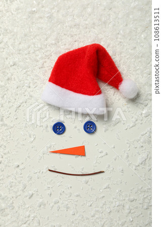 Snowman face with paper carrot and buttons 108613511