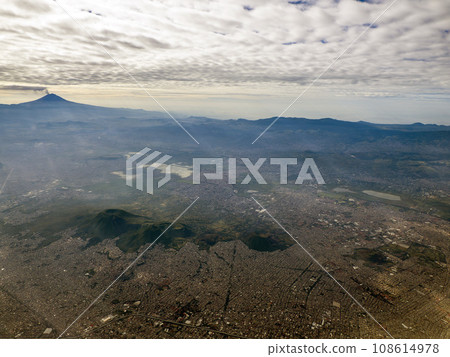 Smoking Popocatepetl volcano in Mexico aerial view with Tetlalmanche volcano Smoking Popocatepetl volcano in Mexico aerial view with Tetlalmanche volcano 108614978