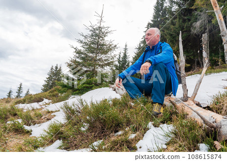 Male hiker enjoys the view at Carpathian mountains at early spring 108615874
