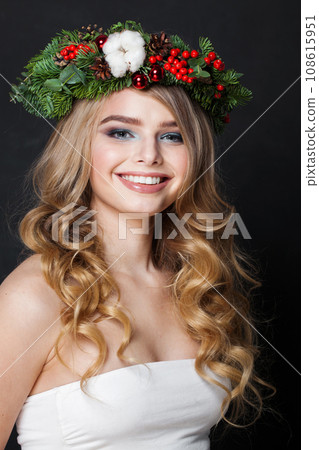 Lovely happy positive female model with long blonde curly hair and makeup posing on black background Lovely happy positive female model with long blonde curly hair and makeup posing on black background 108615951