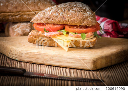 Triangular sandwich with cheese, ham and tomato. 108616090