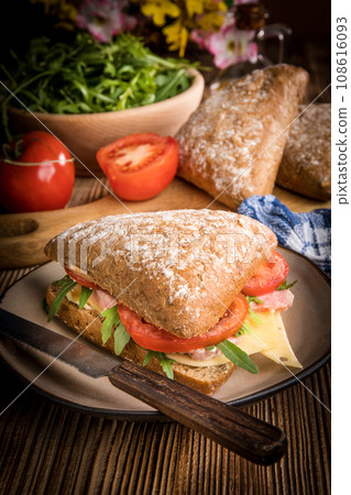 Triangular sandwich with cheese, ham and tomato. 108616093