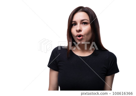 Portrait of a young brunette woman dressed in a black T-shirt on a clean background 108616366