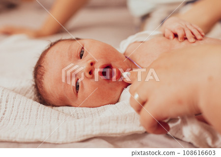 The examination of newborn baby mouth, frenulum of the tongue 108616603