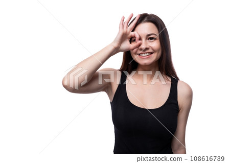Casual pretty young brunette woman wearing a black t-shirt on a white background 108616789