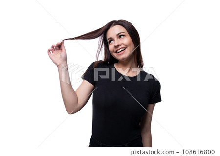Young slender brunette woman with straight short hair wearing a black T-shirt Young slender brunette woman with straight short hair wearing a black T-shirt 108616800