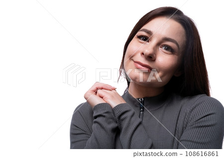 Casual young brunette woman wearing a marsh-colored turtleneck on a white background, close-up 108616861