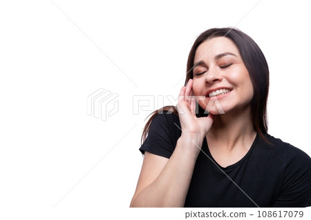 Young modest woman wearing a black T-shirt on a background with copy space 108617079