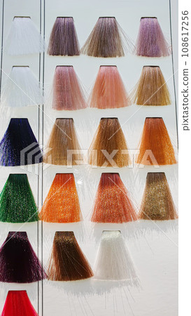 A palette of hair colors made from artificial strands on a white background. Color selection. 108617256