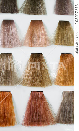 A palette of hair colors made from artificial strands on a white background. Color selection. 108617258