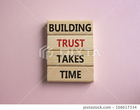 Building Trust takes Time symbol. Wooden blocks with words Building Trust takes Time. Beautiful pink background. Business and Building Trust takes Time concept. Copy space. Building Trust takes Time symbol. Wooden blocks with words Building Trust takes Time. Beautiful pink background. Business and Building Trust takes Time concept. Copy space. 108617334