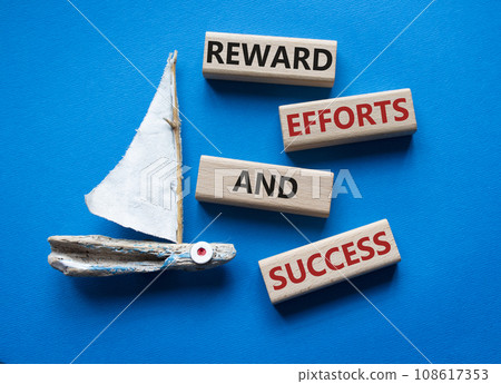 Reward Efforts and Success symbol. Concept words Reward Efforts and Success on wooden blocks. Beautiful blue background with boat. Business concept. Copy space. Reward Efforts and Success symbol. Concept words Reward Efforts and Success on wooden blocks. Beautiful blue background with boat. Business concept. Copy space. 108617353