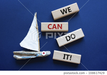 We can do it symbol. Concept words We can do it on wooden blocks. Beautiful deep blue background with boat. Business and We can do it concept. Copy space. We can do it symbol. Concept words We can do it on wooden blocks. Beautiful deep blue background with boat. Business and We can do it concept. Copy space. 108617429