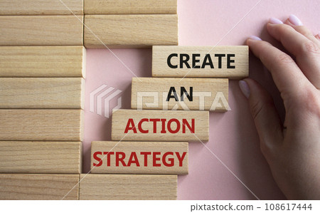 Create an action Strategy symbol. Wooden blocks with words Create an action Strategy. Beautiful pink background. Businessman hand. Business and Create an action Strategy concept. Copy space. Create an action Strategy symbol. Wooden blocks with words Create an action Strategy. Beautiful pink background. Businessman hand. Business and Create an action Strategy concept. Copy space. 108617444