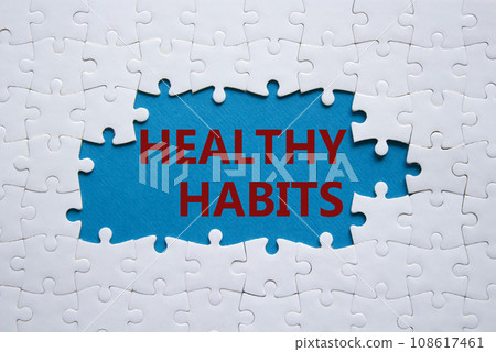 Healthy habits symbol. Concept word Healthy habits on white puzzle blocks. Beautiful blue background. Business and Healthy habits concept. Copy space 108617461