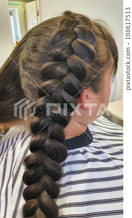 Wedding and holiday hairstyle. Braiding and hair styling in a beauty salon. Wedding and holiday hairstyle. Braiding and hair styling in a beauty salon. 108617513