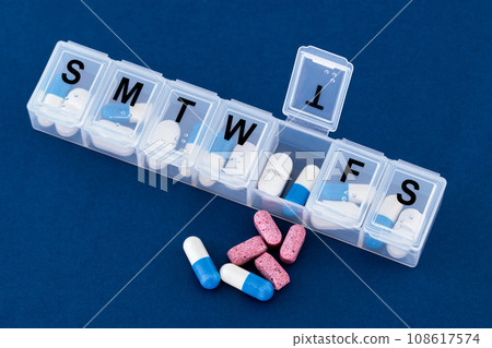 A weekly pills box, tablets, vitamins. A weekly pills box, tablets, vitamins. 108617574