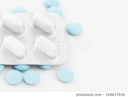 Blister pack with white tablets and blue pills. Blister pack with white tablets and blue pills. 108617630