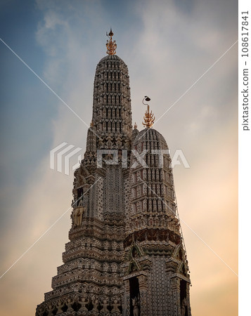 This majestic temple in Bangkok, Wat Arun, is a towering and ornate structure in Thailand with multiple levels and spires. 108617841