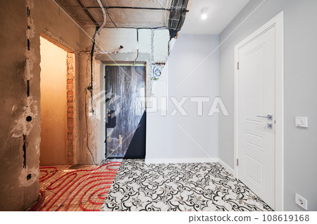 Comparison of old flat with underfloor heating pipes and new renovated apartment with modern interior design. Hallway with heated floor before and after renovation. Comparison of old flat with underfloor heating pipes and new renovated apartment with modern interior design. Hallway with heated floor before and after renovation. 108619168
