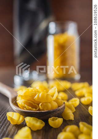 Uncooked gnocchi pasta. Raw italian pasta on wooden table. 108619526