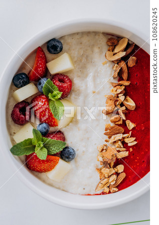 Sweet milk semolina porridge with strawberries on beautiful plate. Delicious breakfast for children 108620245