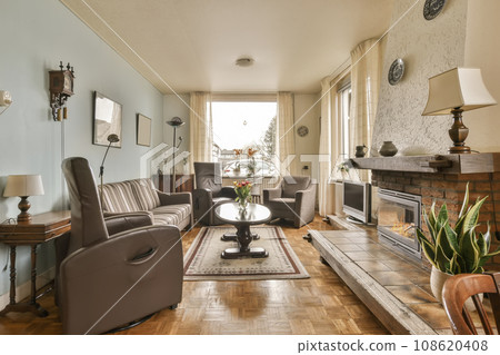 a living room with couches, chairs and a fire place in the middle part of the room is empty a living room with couches, chairs and a fire place in the middle part of the room is empty 108620408