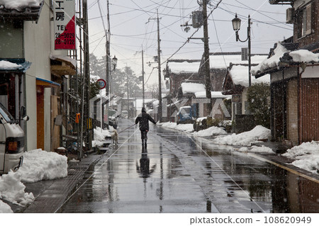 Walking the road on a snowy day Walking the road on a snowy day 108620949