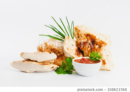 Chicken fillets fried until half cooked, semi-finished product with fresh herbs on a white background. Fast food. Quick cooking at home. Copy space.Fast cooking.Fast homemade food. Chicken fillets fried until half cooked, semi-finished product with fresh herbs on a white background. Fast food. Quick cooking at home. Copy space.Fast cooking.Fast homemade food. 108621568
