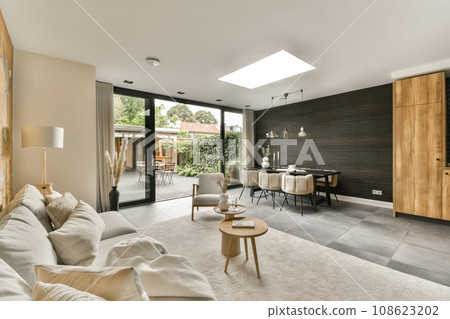 a living room with wood paneled walls and white rugs on the floor in front of the couches a living room with wood paneled walls and white rugs on the floor in front of the couches 108623202
