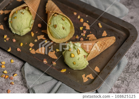 Pistachio ice cream in waffle cones 108625125