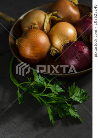 Fresh whole onions and parsley Fresh whole onions and parsley 108625140