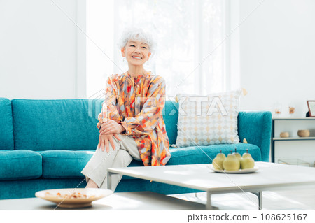 Senior woman relaxing in the living room Senior woman relaxing in the living room 108625167