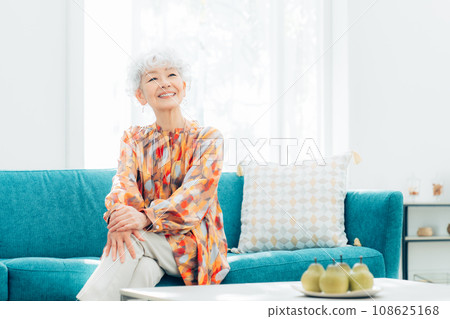 Senior woman relaxing in the living room 108625168
