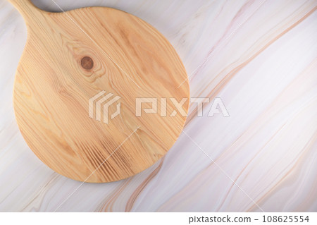 Wooden cutting board on a gray marble background 108625554