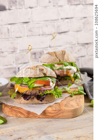 Healthy vegan burger with fresh vegetables and yogurt sauce 108625694