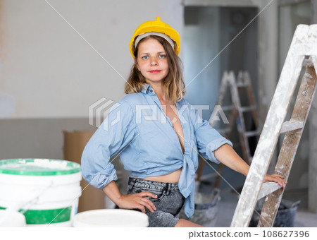 Tempting woman in revealing attire posing in construction site 108627396