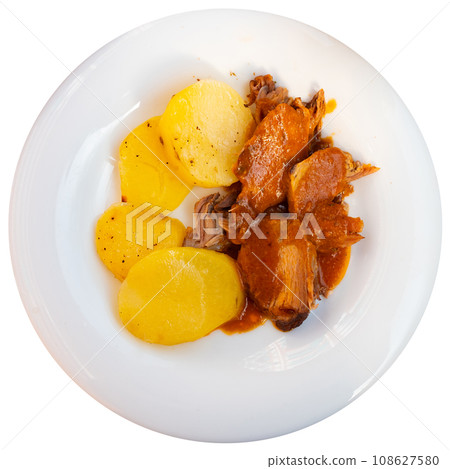 Braised pork in tomato sauce, served with bread and wine, closeup 108627580